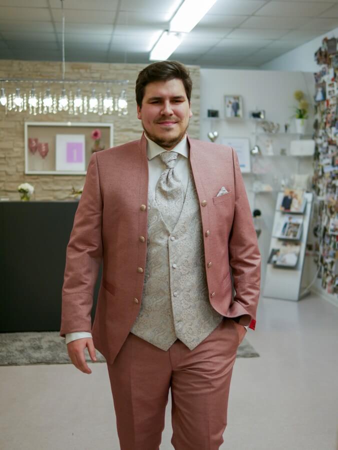 a man in a pink suit